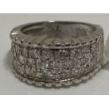 18 ct white gold 1ct diamond ring consisting of three rows of diamonds set into the thick band,