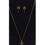14ct yellow gold garnet necklace and earring set, the pendant features a central rectangular