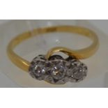 18ct yellow gold tri-stone diamond ring in a cross over design setting, marked 18CT, approx 0.