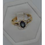 18ct yellow gold diamond and sapphire ring, approx size M/N. Oval central sapphire approx .50ct,