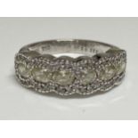 Ladies white gold eternity ring, with central row of oval cut diamonds with smaller chip diamonds to