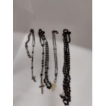 A trio of vintage rosaries together with a faceted necklace (possibly French jet)