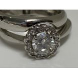 Platinum two-piece diamond cluster ring and interlocking band set, central stone in raised claw
