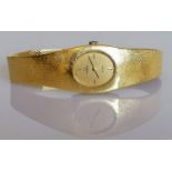 A ladies 18ct yellow gold Omega De Ville wristwatch, the rectangular case enclosing oval champagne