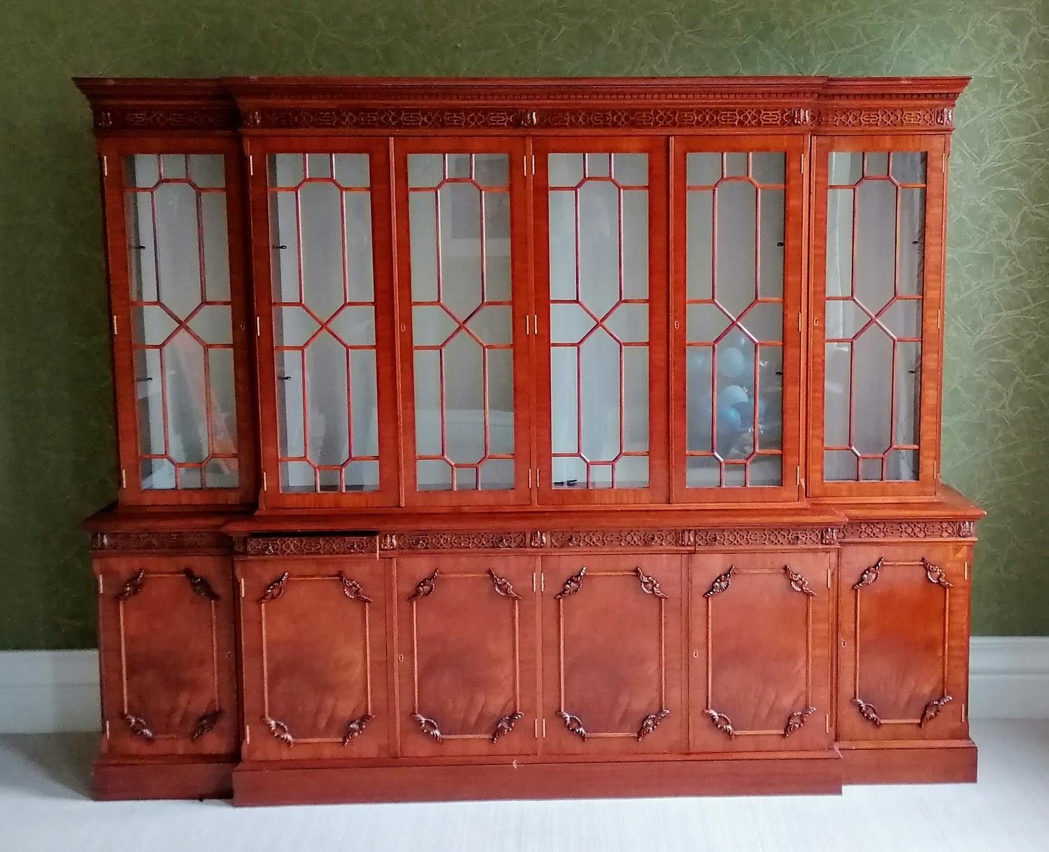 A Chippendale-style breakfront mahogany six-door bookcase with astragal front, blind carving to