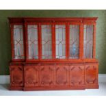 A Chippendale-style breakfront mahogany six-door bookcase with astragal front, blind carving to