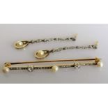 An Art Deco diamond and pearl bar brooch, 70mm. with a pair of near matching earrings, each 50mm,