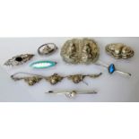 A selection of seven silver based brooches, one necklace and two others