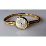A Garrard mid-century ladies 9ct gold presentation watch with baton numerals, in working order,