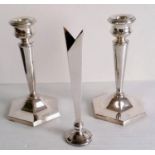 A matching pair of silver tapering candlesticks on hexagonal bases and a silver posy holder, all