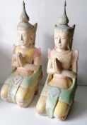 A pair of painted wood carved Oriental kneeling Buddha figurines, each 54 cm H, some paint peeling