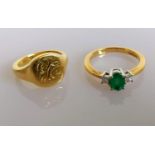 An oval emerald (6mm x 4mm) and diamond ring on yellow gold with an initialled signet gold ring,