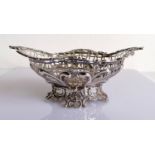 An oval Victorian pierced silver basket with C-scroll decoration by William Comyns, London, 1890,