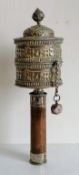 A Tibetan silver prayer wheel with hardwood handle, 26 cm long