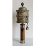 A Tibetan silver prayer wheel with hardwood handle, 26 cm long