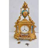 A 19th century French gilt mantle clock surmounted by a Sevres-style urn with classical depiction