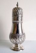 An Edwardian silver sugar shaker with spiral embossed decoration, shaped finial by Atkin Brothers,