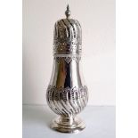 An Edwardian silver sugar shaker with spiral embossed decoration, shaped finial by Atkin Brothers,