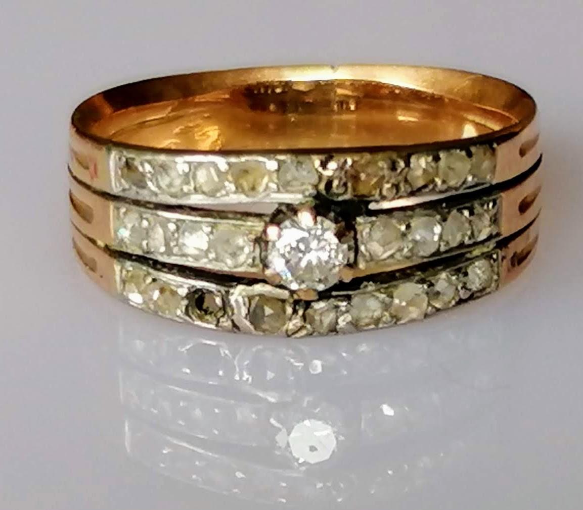 An Art Deco diamond and gold ring with triple-split shank, pave-setting with old-cut and central