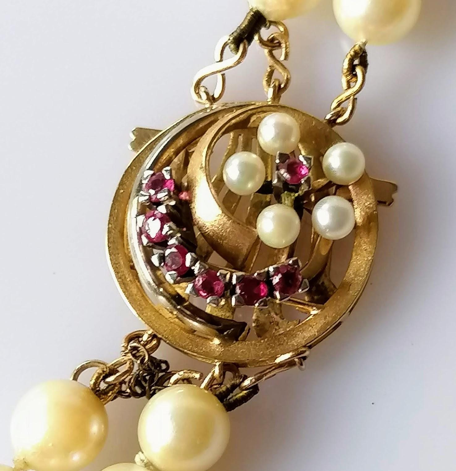 A double rope of cultured pearls with gold and garnet decorated clasp, 56 cm, not marked