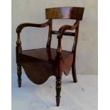 A George IV mahogany commode chair with shaped support, carved arms, lift-up seat on turned legs, 87