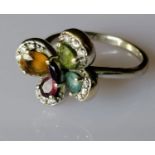 An 18ct white gold multi-gem flower ring with diamond decoration, size L, hallmarked, 4.79g