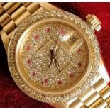 A Rolex ladies 18K gold diamond and ruby-set automatic wristwatch, with centre sweep seconds hand,