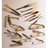 An assortment of eleven Edwardian mother-of-pearl and ivory-handle pen knives, some with