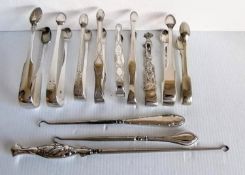 An assortment of nine silver sugar tongs, mostly George III, GIV with bright-cut decoration; various