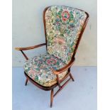 An Ercol beechwood Windsor stick-back armchair with swept arms, loose cushions, splay legs and