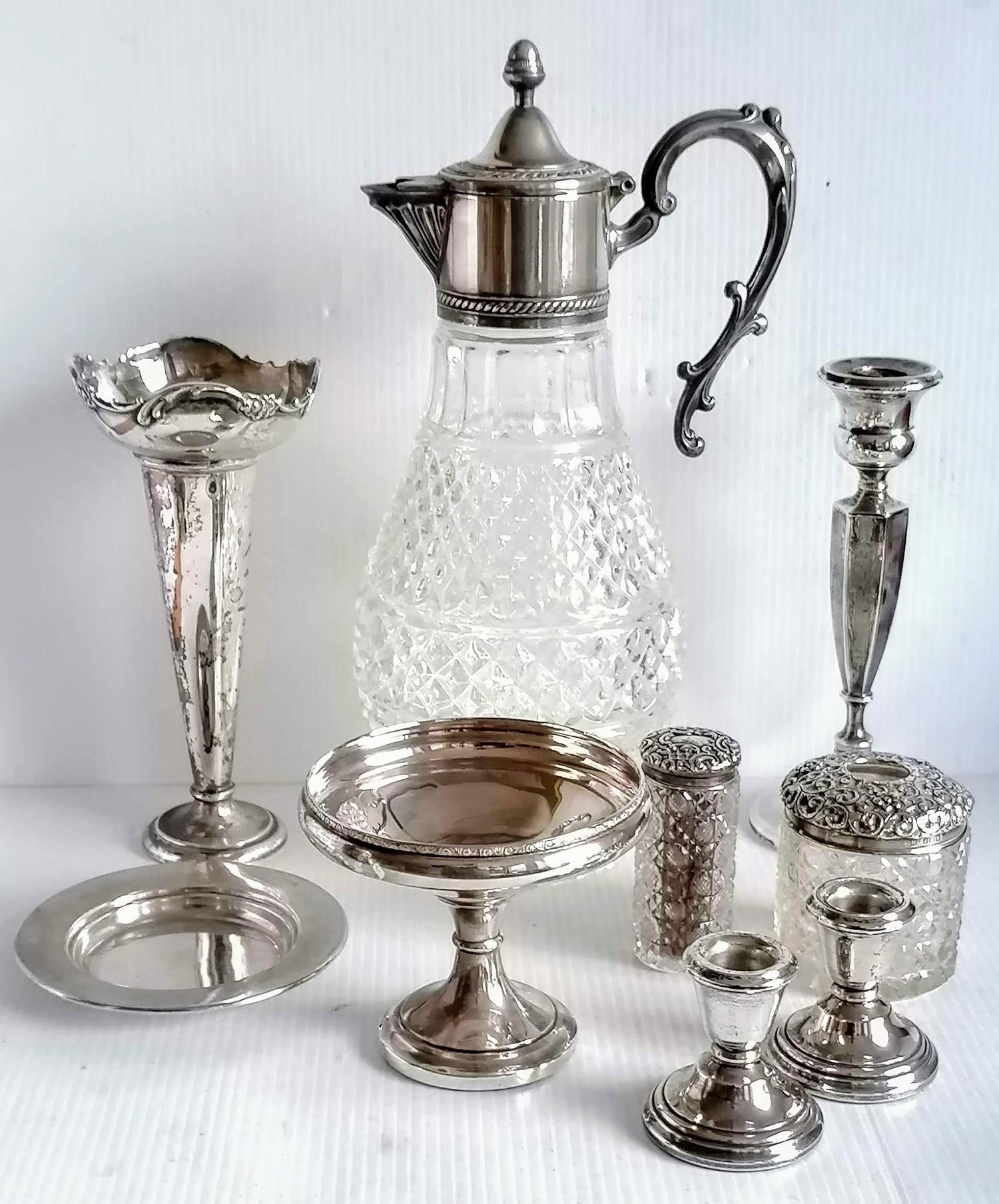 An assortment of late Victorian and Edwardian silver to include a pair of dwarf candlesticks,