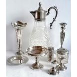 An assortment of late Victorian and Edwardian silver to include a pair of dwarf candlesticks,