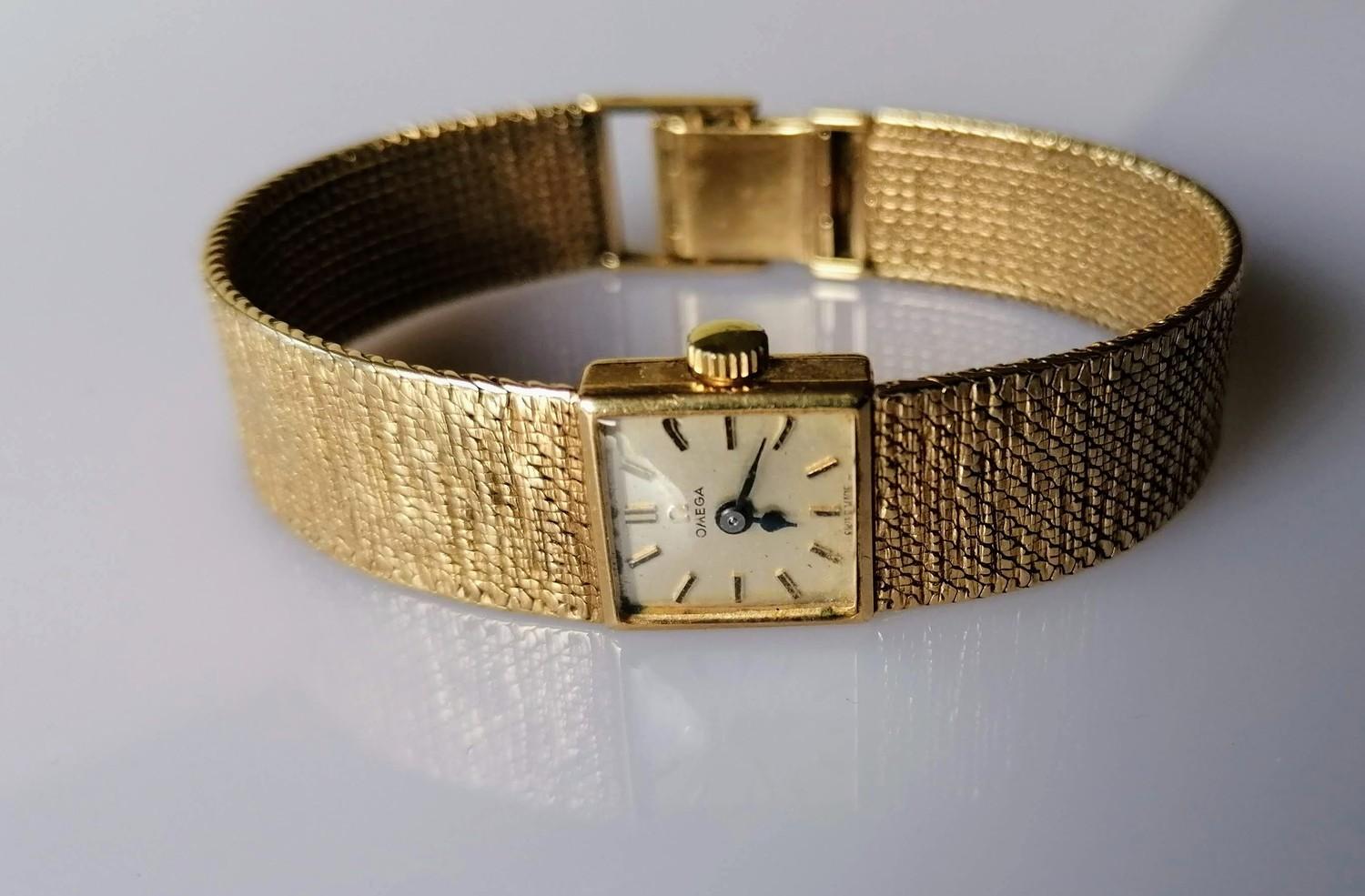 A mid-century Omega ladies dress watch with a gold case and bark-effect bracelet strap, in working