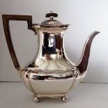 An Edwardian silver coffee jug with fruitwood handle, gadroon rim on ball feet by John Round & Son