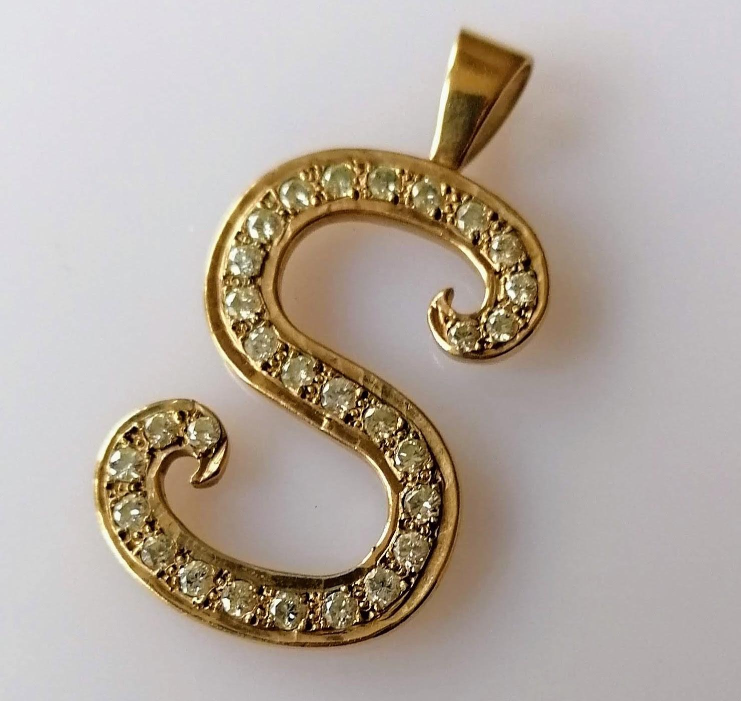 A mid-century yellow gold and pave-set diamond S-shape pendant, approximate total diamond weight 2