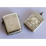 A late Victorian silver vesta case with engine turned decoration and dedication, another with