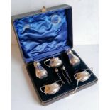 An Edwardian cased silver condiment set comprising two salts, mustard, salt, pepper with three