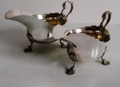 A pair of Georgian-style silver sauceboats with scallop decoration by Harrods, (sponsor Richard