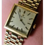 A mid-20th century Omega manual men's wristwatch with 9ct yellow gold bracelet strap, square dial,