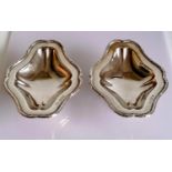 A pair of George V silver tazze with decorated borders, each on a spreading foot by Skinner & Co.,