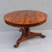 A recently restored George IV-style rosewood circular breakfast table on a gun barrel support,