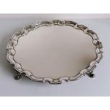 A George II silver salver with pie-crust border on four hoofed feet, initialled to underside, by