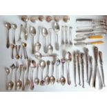 A miscellany of silver flatware to include souvenir spoons, forks, knives, button hooks, bottle