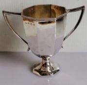 A George V silver octagonal, two-handled trophy cup with reeded decoration to rim by C.P & Co,