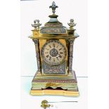 A French 19th century brass mantle clock with Roman numerals, carved bezel with mechanism by AD