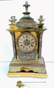 A French 19th century brass mantle clock with Roman numerals, carved bezel with mechanism by AD