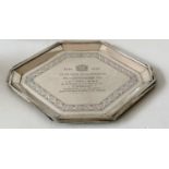 An Art Deco silver octagonal presentation tray with shaped rim and isometric border decoration to