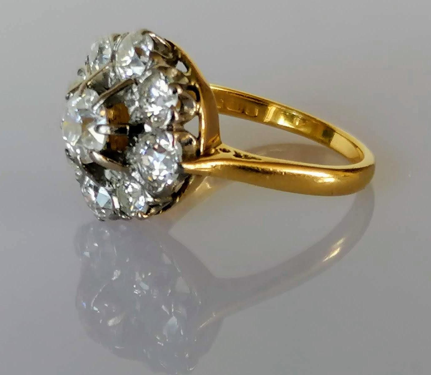 A diamond cluster ring on a claw-set yellow and white 18ct gold setting: the central old European- - Image 6 of 8