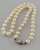 A single row necklace of forty-five cultured pearls measuring 7.4mm to 8mm on a navette-shape clasp,