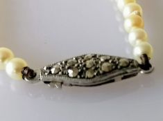 An Art Deco single row of one hundred and three graduated cultured pearls measuring 3.45mm to 7.43mm